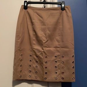 White House black market tan pencil skirt with gold grommets.